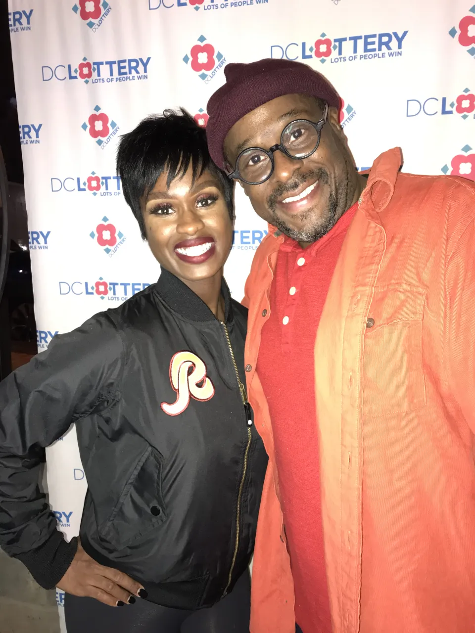 Man posing for a photo with a cheerleader