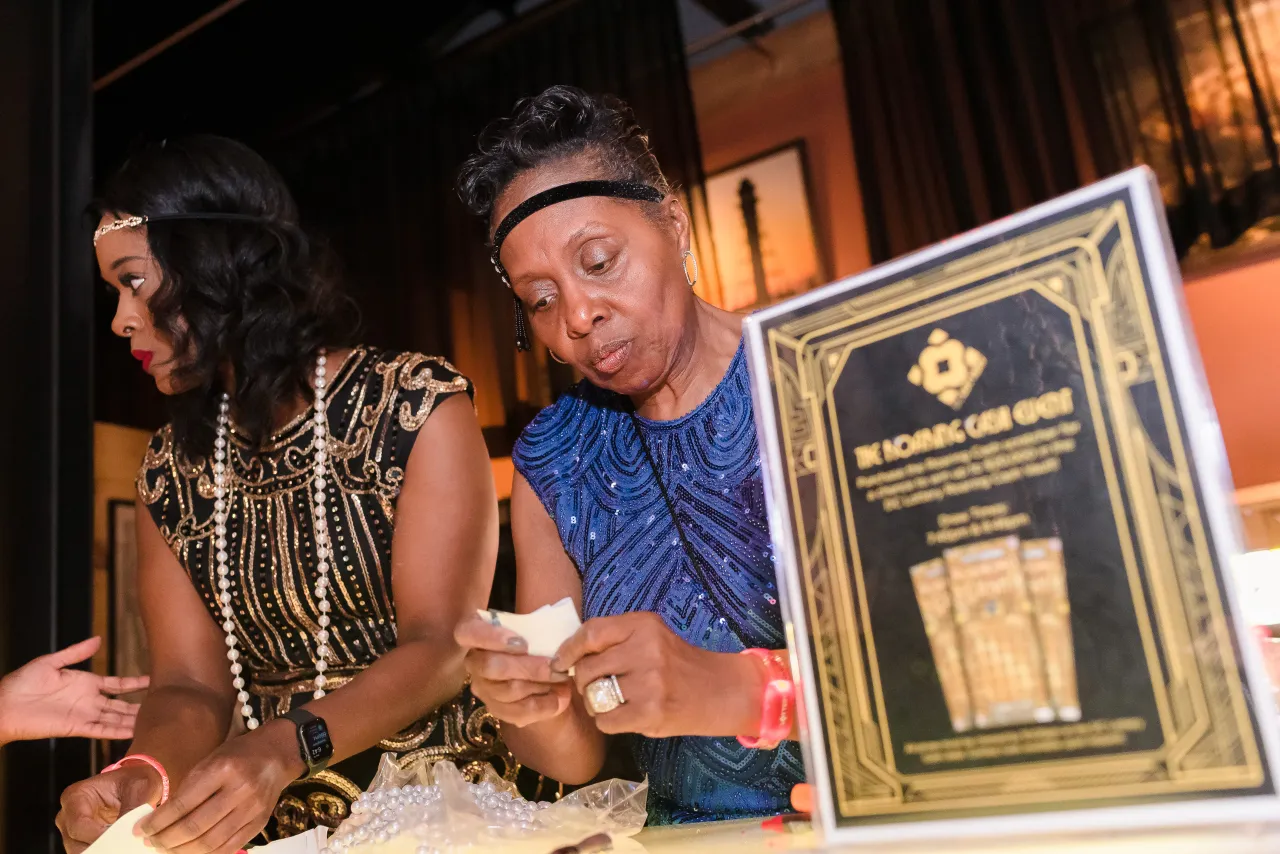 Two women collecting entry forms