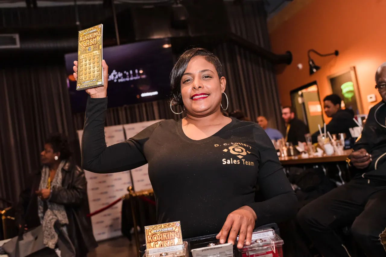 Woman selling Roaring Cash ticket