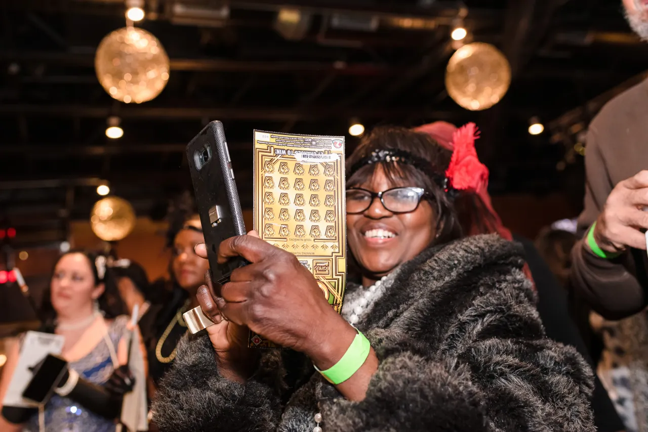 Woman holding Roaring Cash Ticket