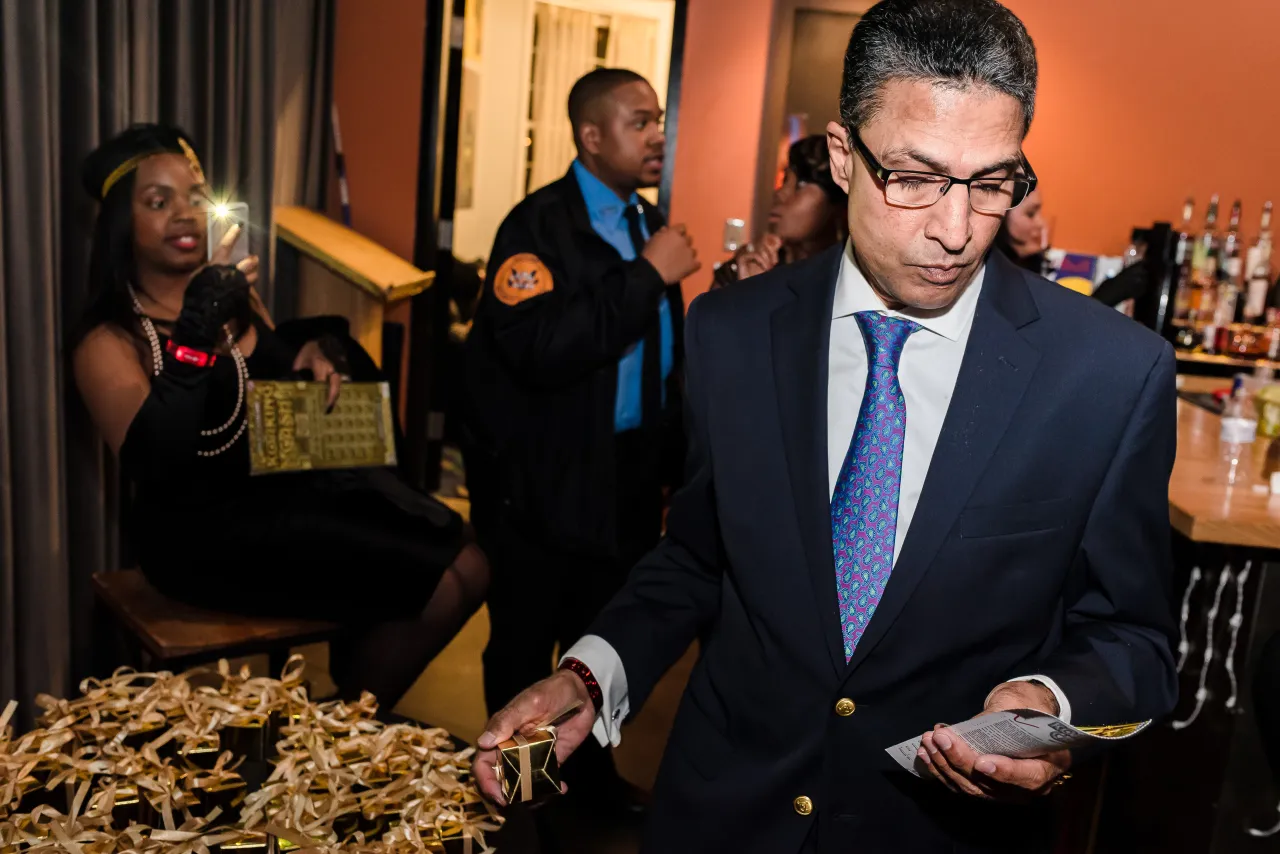 Man picking a small gold gift box