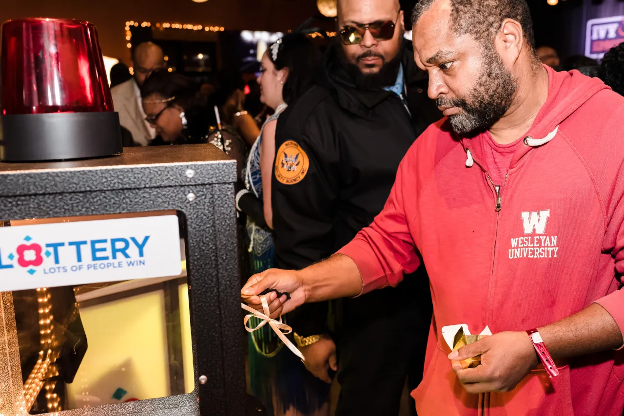 Man trying to open the DC Lottery cash vault game