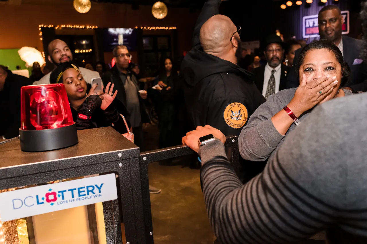 Woman opening DC Lottery Cash Vault game