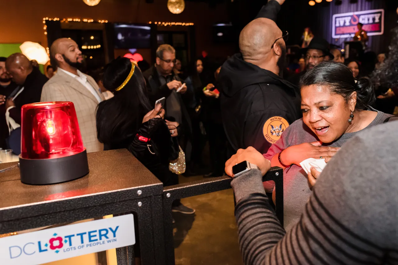 Woman opening DC Lottery Cash Vault game